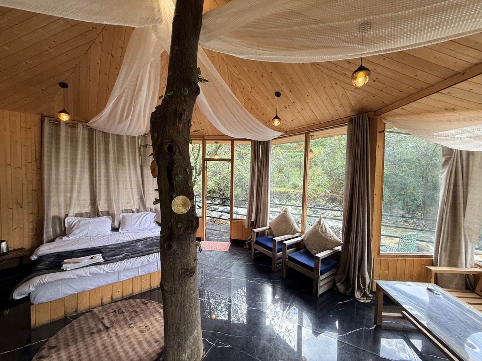 The Treehouse interior built around a living tree, with river views